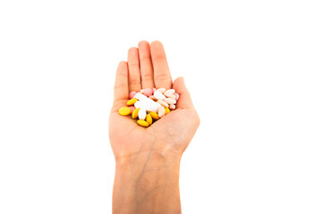 Hand with handful of scattered medicines, pills and tablets on white background.