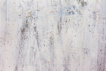 Dirty concrete wall with yellow streaks of water, cracks and scratches. Grungy concrete surface. Great background or texture for your project.