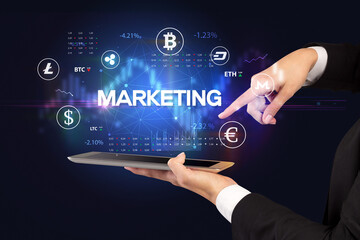 Close-up of a touchscreen with MARKETING inscription, business opportunity concept