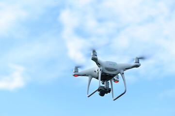 Fototapeta na wymiar White drone with camera flying in the air