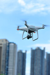 Fototapeta na wymiar White drone with camera flying in the air