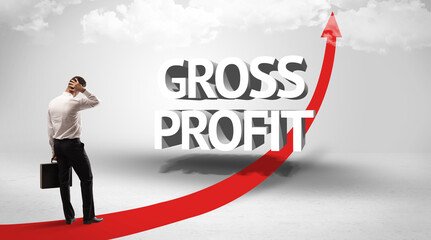 Rear view of a businessman standing in front of GROSS PROFIT inscription, successful business concept