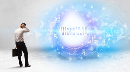 Rear view of a businessman standing in front of VIRTUAL inscription, modern technology concept