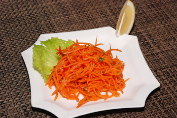 korean carrot salad with lemon on the white plate