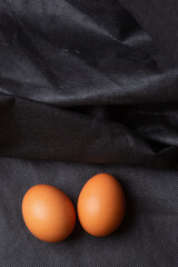 Eggs on black fabric background