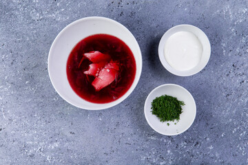 traditional beetroot soup in a plate on a gray background