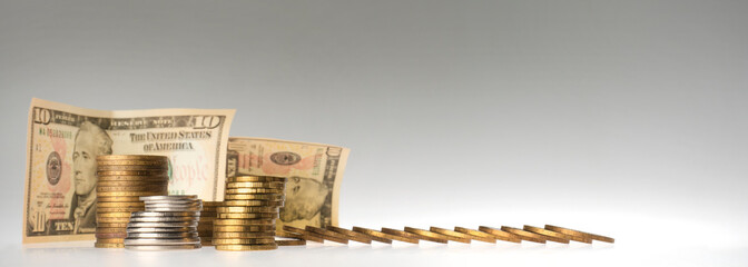 finance. stacks of coins and paper bills on a gray background