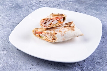 shawarma in a plate on a gray background. close-up