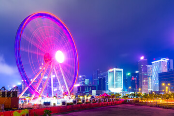 Hong Kong Observation Wheel against skyscrapers and modern buildings near central pier. Long...