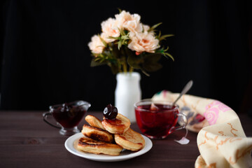 Pancakes with jam. Photo of a glass of tea and pancakes.