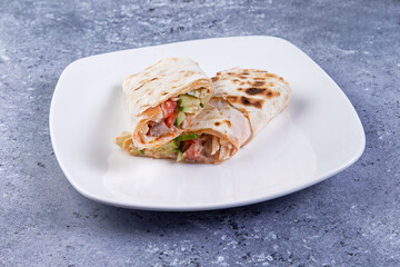 shawarma in a plate on a gray background. close-up