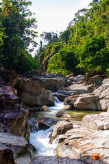 Fototapeta na wymiar Amazing river with smooth rocks and series of waterfalls in the rainforest on Oriental Mindoro, Philippines