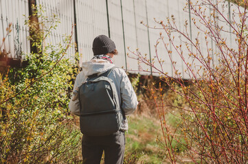 Naklejka premium A girl with a backpack goes into the wilderness. Going on an expedition in the North of Russia