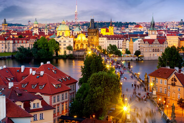 Aerial view of Charles Bridge, old town and Zizkov TV Tower in Prague, Czech Republic during sunset...