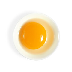 Fresh raw egg, white and yolk, in bowl isolated on white background top view