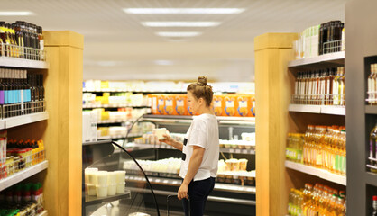Woman choosing a dairy products at supermarket	