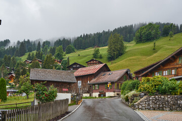 Fototapeta na wymiar Traditional wooden houses of Swiss Alps. Taken in Mürren, above Lauterbrunnen Valley, Switzerland 