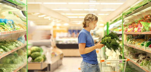 Young man buying vegetables at the market	