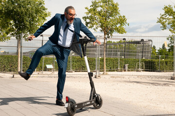 elderly business man with scooter outdoor