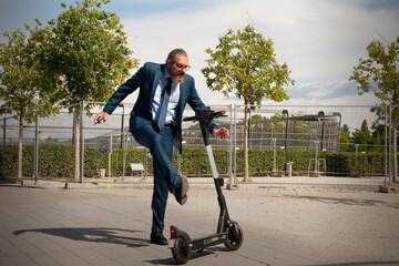 elderly business man with scooter outdoor