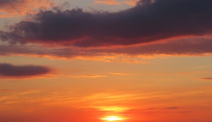 Beautiful orange burgundy sunset in the sky, natural colorful cloudscape