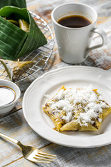 Lupis cake, a traditional Indonesian snack made from sticky rice. Served with grated coconut and brown sugar.