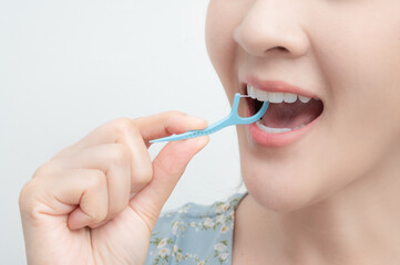 A Woman Cleaning Teeth With Dental Floss , Dental care , Tooth decay concept.