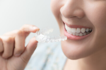 Woman wearing orthodontic silicone trainer. Mobile orthodontic appliance for dental correction....