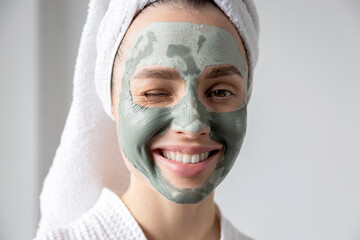 Funny  girl in a green clay mask
