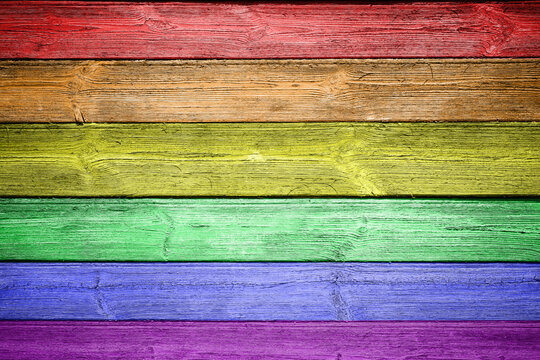 Wooden wall painted in the colors of the rainbow. LGBT movement concept.