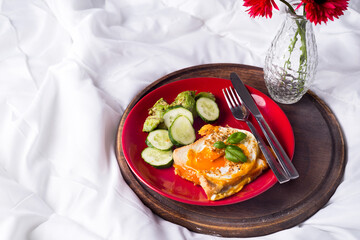 Fried eggs with toasts and tea in bed