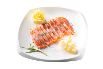 Raw salmon fillet pieces served with spices, lemon, butter and herbs on white plate isolated on white background