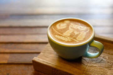 Latte art coffee on wooden table