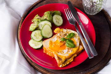 Fried eggs with toasts and tea in bed