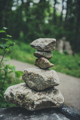 Fototapeta na wymiar Rock stack in park, balanced, zen art - bold and moody