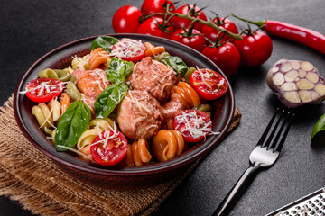 Delicious fresh pasta with meatballs, sauce, cherry tomatoes and basil