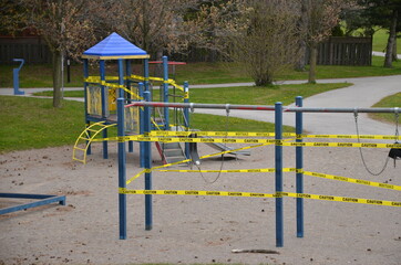 Fototapeta na wymiar A COVID-19 closed playground and equipment in Scarborough, Ontario. This closure is part of the City of Toronto’s ongoing efforts to stop the spread of COVI