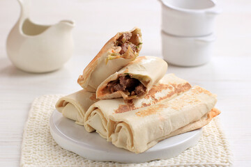 Isolated White Background Frozen Kebab or Shawarma Roll Close up of Street Food Stall Cooking Fresh Asian kebab. Meat Wrapped with Shawarma