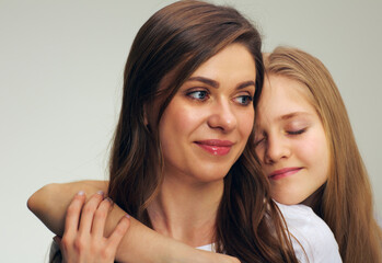 Daughter hugs his mother isolated studio portrait