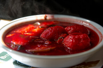 Traditional hot red beet Kubbe soup, a famous middle eastern dumplings soup dish, served in a bowl. Jerusalem, Israel. 