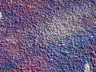 Hooligan smeared paint the walls of the old building. Landscape style. Grungy concrete surface with cracks, scratches and streaks of paint. Great background or texture.