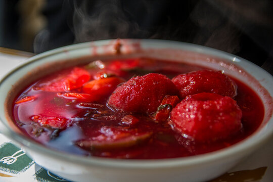 Traditional hot red beet Kubbe soup, a famous middle eastern dumplings soup dish, served in a bowl. Jerusalem, Israel. 