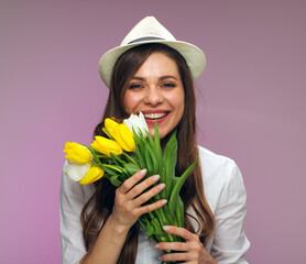 Close up face portrait of happy woman holding flowers.