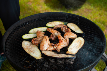 Juicy meat with grilled vegetables (Steak, pork, beef, pepper, salt, grill). The cook pours beer on the juicy meat