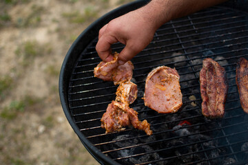 Juicy meat with grilled vegetables (Steak, pork, beef, pepper, salt, grill). The cook pours beer on the juicy meat