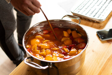 Finely sliced oranges for a drink. Delicious sweet drink with orange juice. Chopped oranges and...