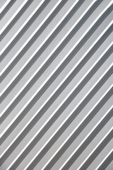 Painted ribbed metal surface with diagonal stripes, texture background.