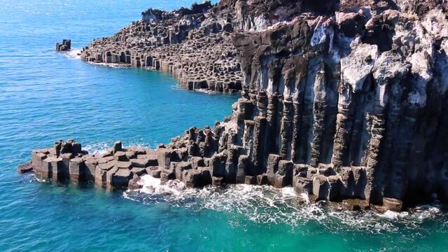 Jungmun Daepo Coast and Jusangjeolli Cliff. Cliff is a spectacular volcanic rock formation at the southern coast of Jeju Island, South Korea. Created when lava from Hallasan Mount erupted into the sea