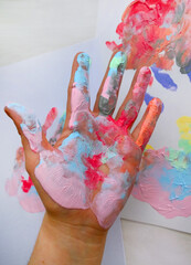 the imprint of a human hand with colorful paint and paint on the hand