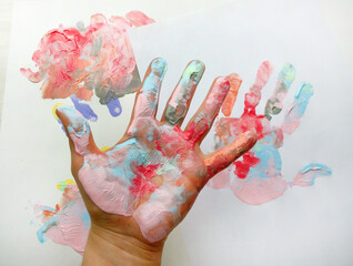the imprint of a human hand with colorful paint and paint on the hand
